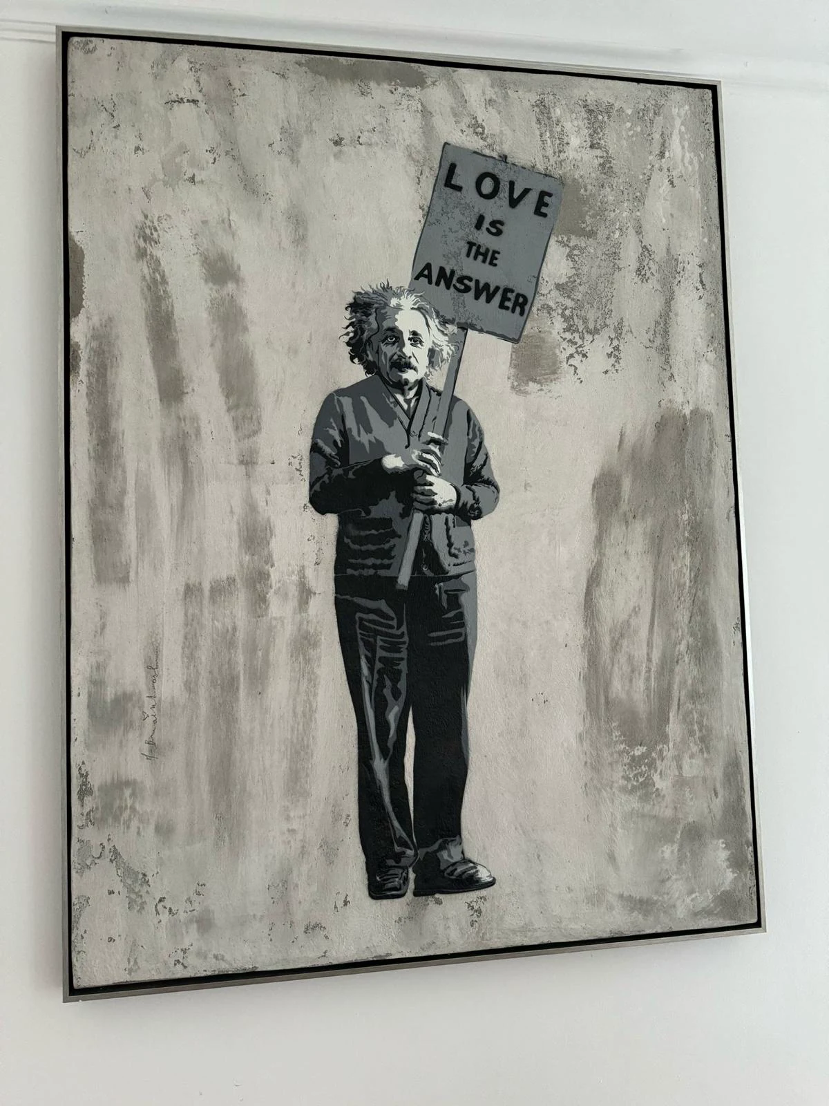 Einstein holding a Love is the Answer sign, stencil and mixed media work by Mr. Brainwash