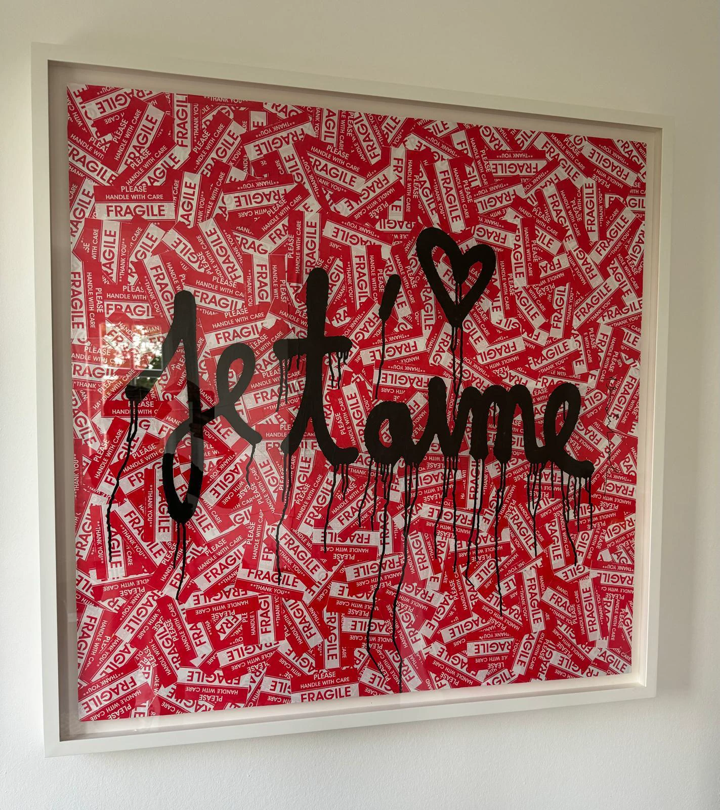Je t'aime, a red fragile-sticker and black spray-paint work by Mr. Brainwash